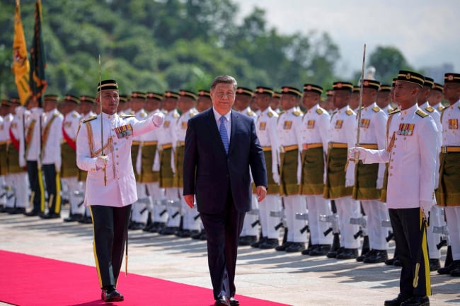 Chinese President Xi Jinping inspects an honor guard during the official welcoming ceremony at the national palace, in Kuala Lumpur, Malaysia, on April 16, 2025.
