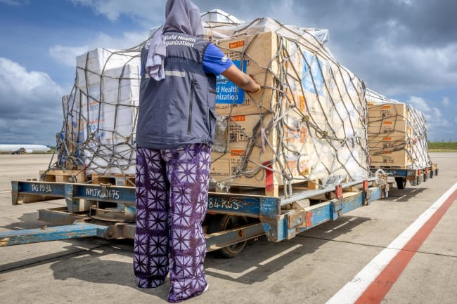 The regional supply chain lead for emergencies at the World Health Organization's Regional Office for Africa pastes stickers on shipment pallets that are being sent in response to the Ebola outbreak in the Democratic Republic of Congo, in Nairobi, Kenya, on May 18, 2026.