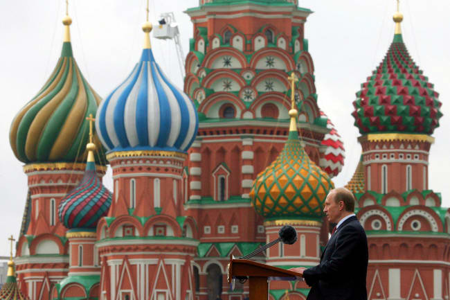 An earlier Victory Day: Russian President Vladimir Putin speaks during a military parade in Red Square in Moscow, May 9, 2005. The photo shows Putin in profile in front of St.Basil's Cathedral in Red speaking at a podium. REUTERS/Grigory Dukor