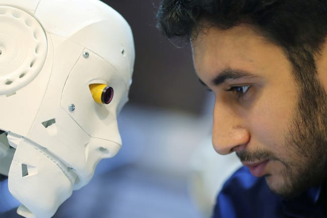 The remote-controlled robot built by Egyptian mechanical engineer Mahmoud El komy to test people for coronavirus by running PCR tests, limiting exposure to suspected cases, is pictured in Cairo, Egypt, on June 12, 2020. Picture shows the robot and inventor eye-to-eye. REUTERS/Mohamed Abd El Ghany
