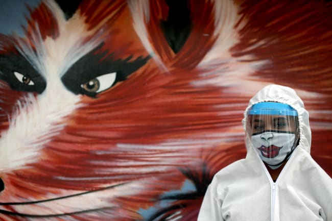 A city employee wearing protective gear poses for a photo during a citywide personal care day, amid the coronavirus disease outbreak in Bogota, Colombia on April 17, 2020.