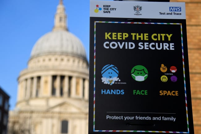 A public health information sign is seen with St. Paul's Cathedral seen behind amidst a lockdown during the spread of the coronavirus disease pandemic, London, Britain, January 7, 2021.