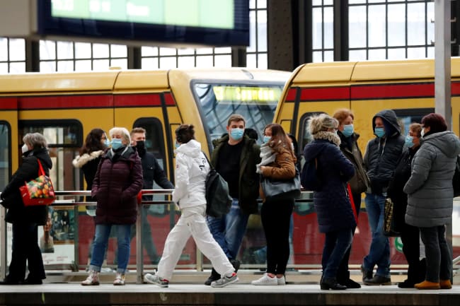 Passengers wear face masks as they wait for an S-Bahn commuter train on the platform at Friedrichstrasse station during lockdown amid the coronavirus pandemic, in Berlin, Germany on February 5, 2021.