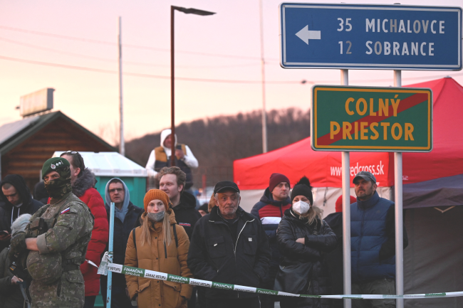 People wait at the Ukrainian border in Vysne Nemecke, Slovakia after Russia launched a massive military operation against Ukraine