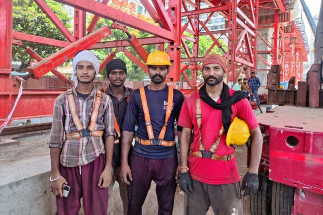 A group of construction workers stand for a photo, in Mumbai, India, June 12, 2024.