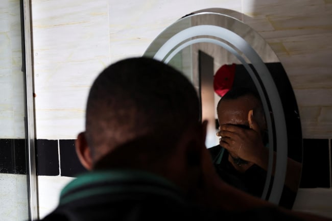 A person who contracted HIV after losing access to PrEP, washes his face, in Asaba, Delta State, Nigeria, on May 31, 2025.