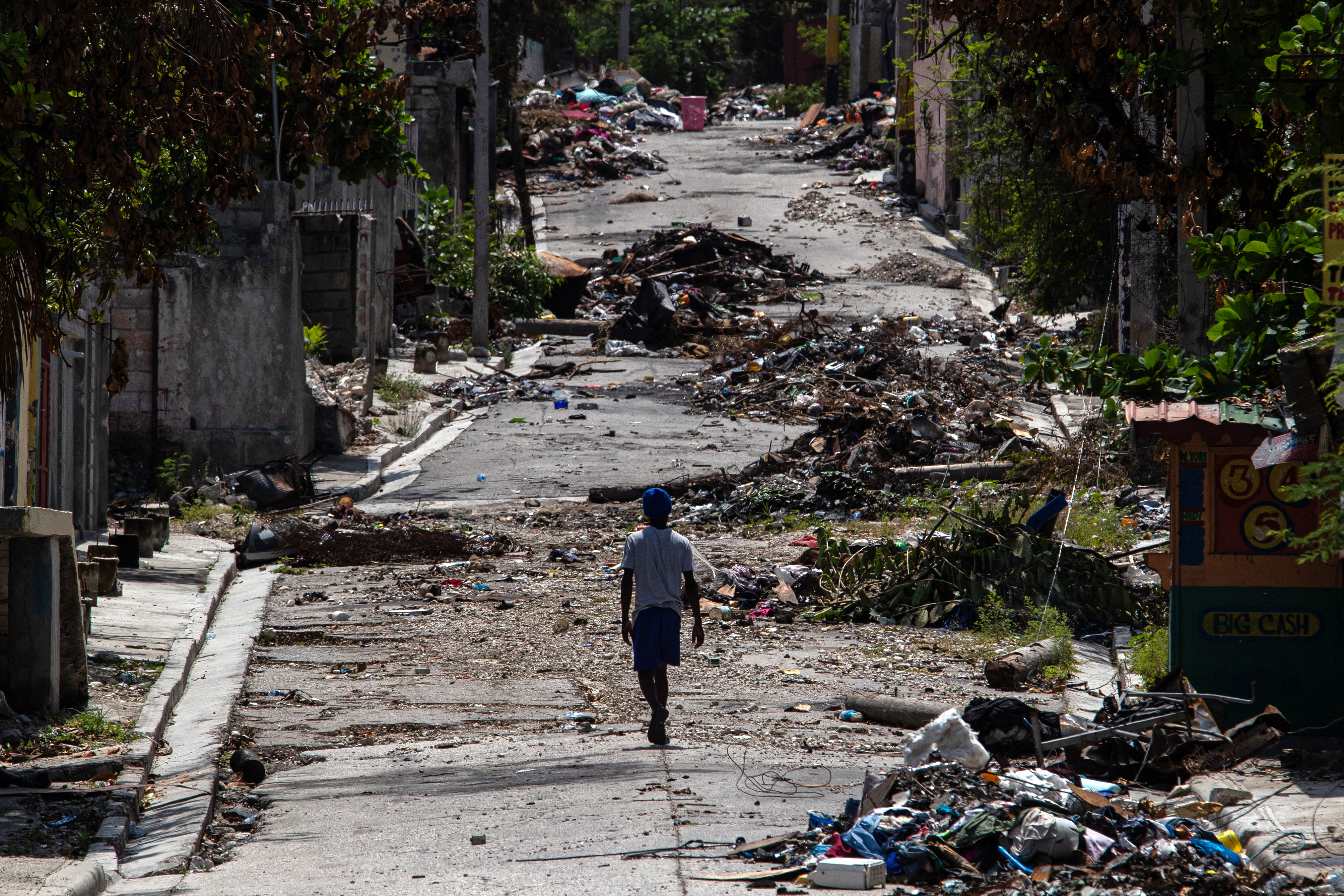 A photo of a person walking amid debris in Port-au-Prince, Haiti