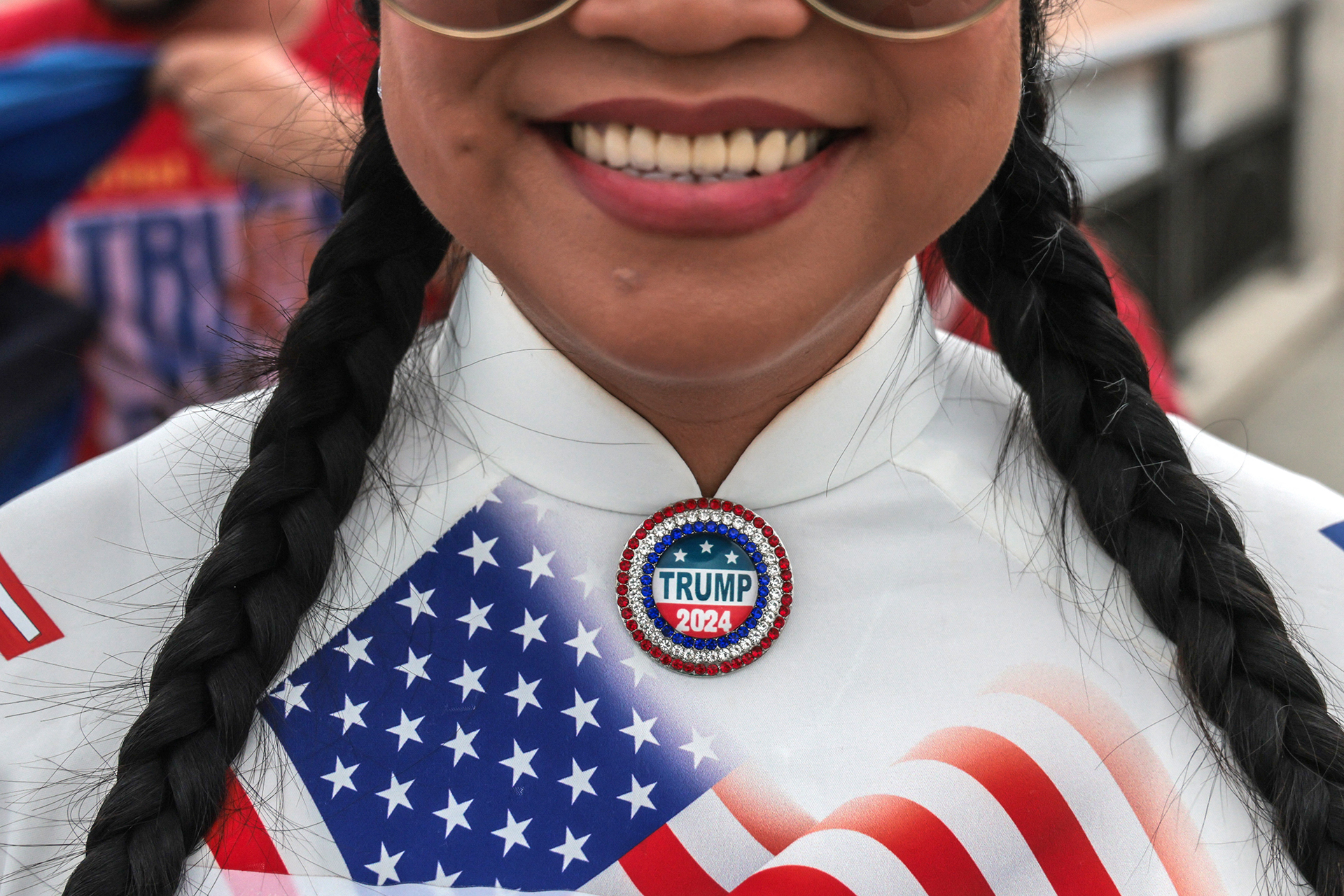 A supporter of U.S. President and Republican presidential candidate Donald Trump wears a "Trump 2024" pin near his Mar-a-Lago resort in Palm Beach, Florida, on Election Day, November 5, 2024.