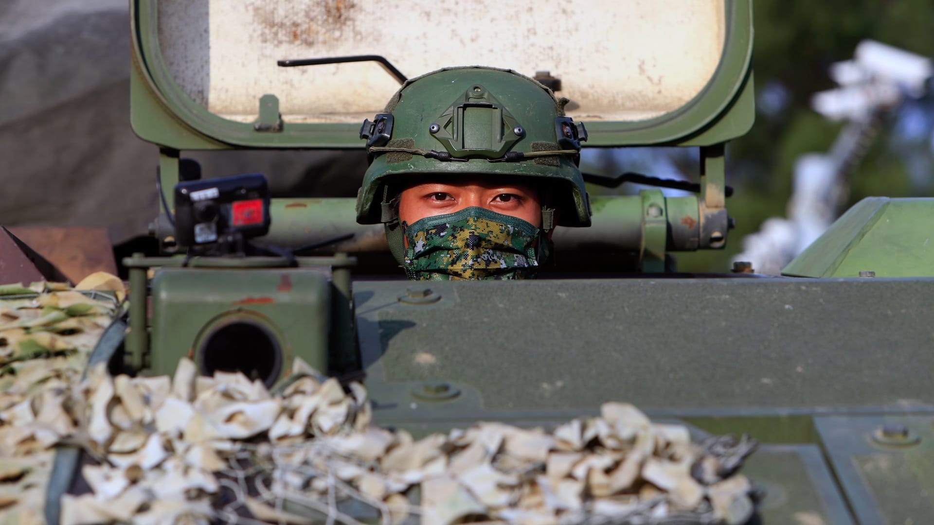 <p>A Taiwanese soldier peers out of a tank during the thirty-seventh annual Han Kuang military exercise in Tainan, Taiwan, on September 14, 2021.</p>

