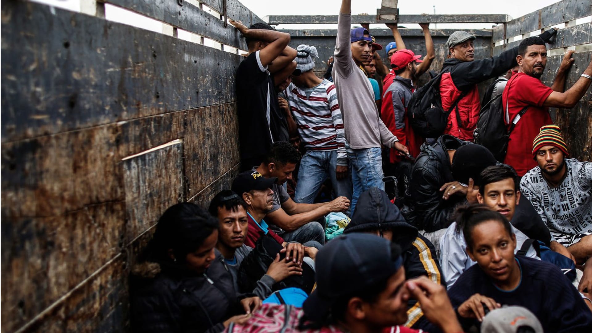 <p>Venezuelan migrants travel aboard a truck in Tumbes, Peru, on November 1, 2018.</p>
