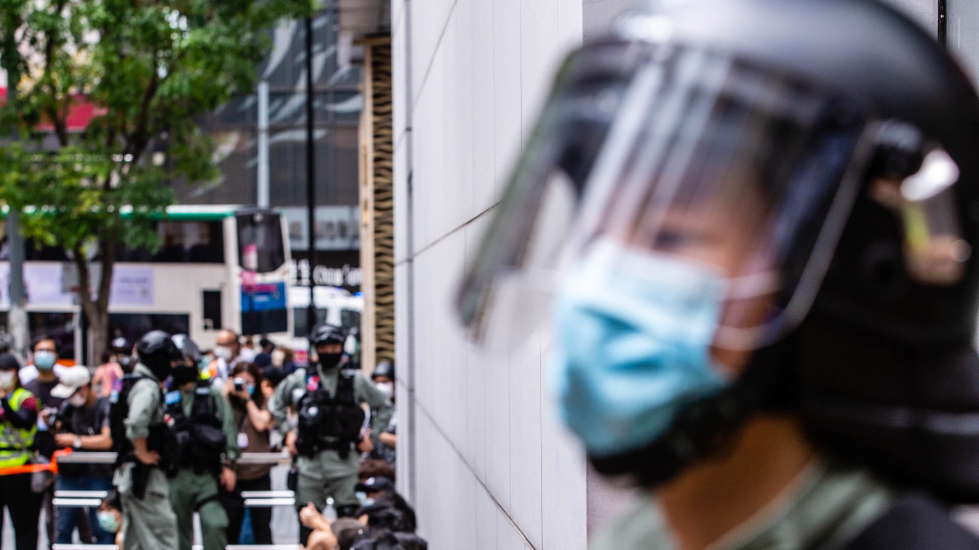 Riot police round up a group of protesters during the