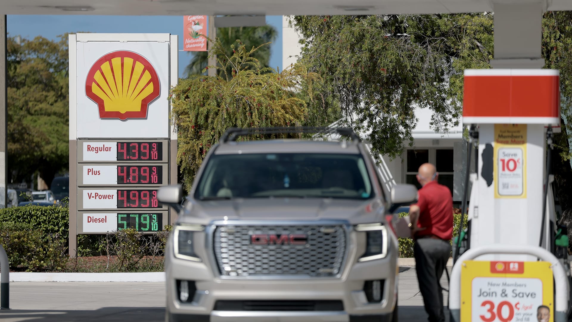 Fuel prices are displayed on a sign as a customer fills their vehicle at a gas station on April 13, 2026 in Miami, Florida.