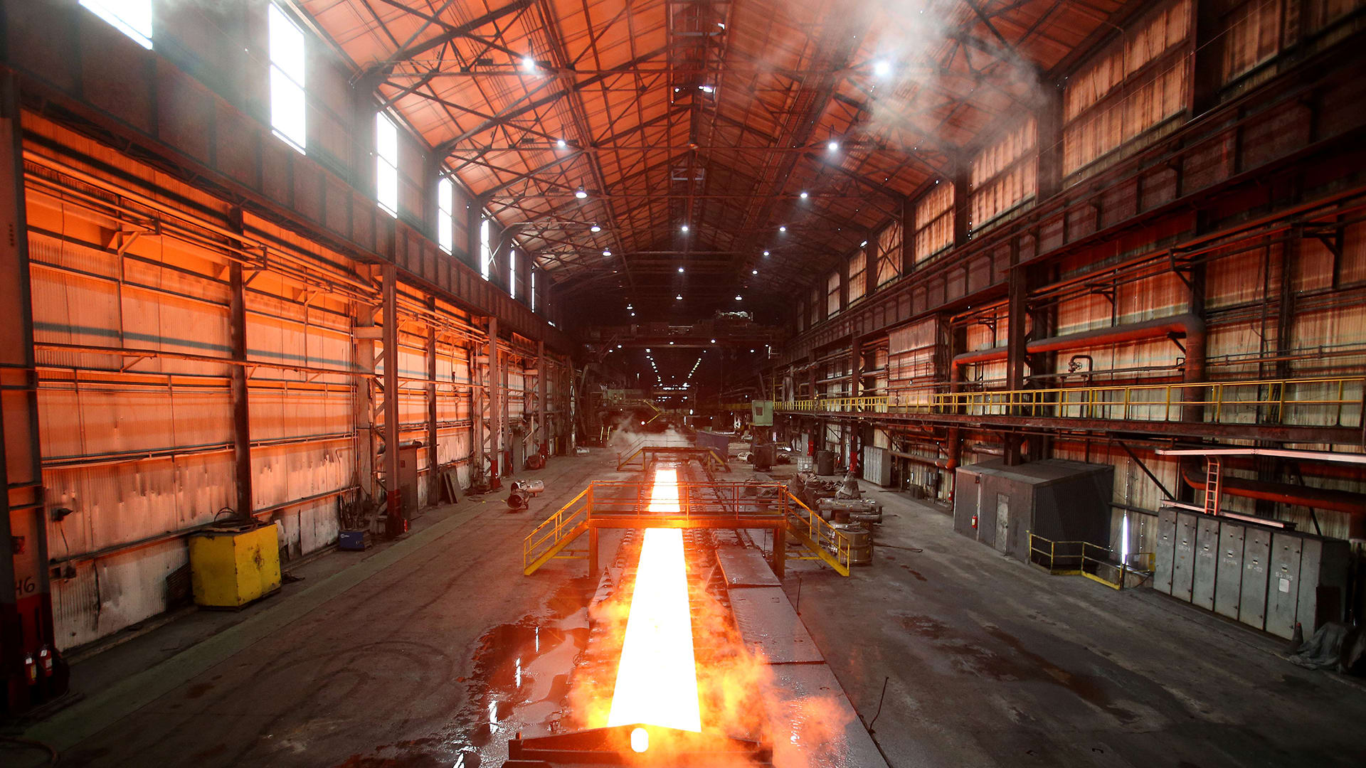 Steam rolls off a slab of steel as it rolls down the line at the Novolipetsk Steel PAO steel mill in Farrell, Pennsylvania,
