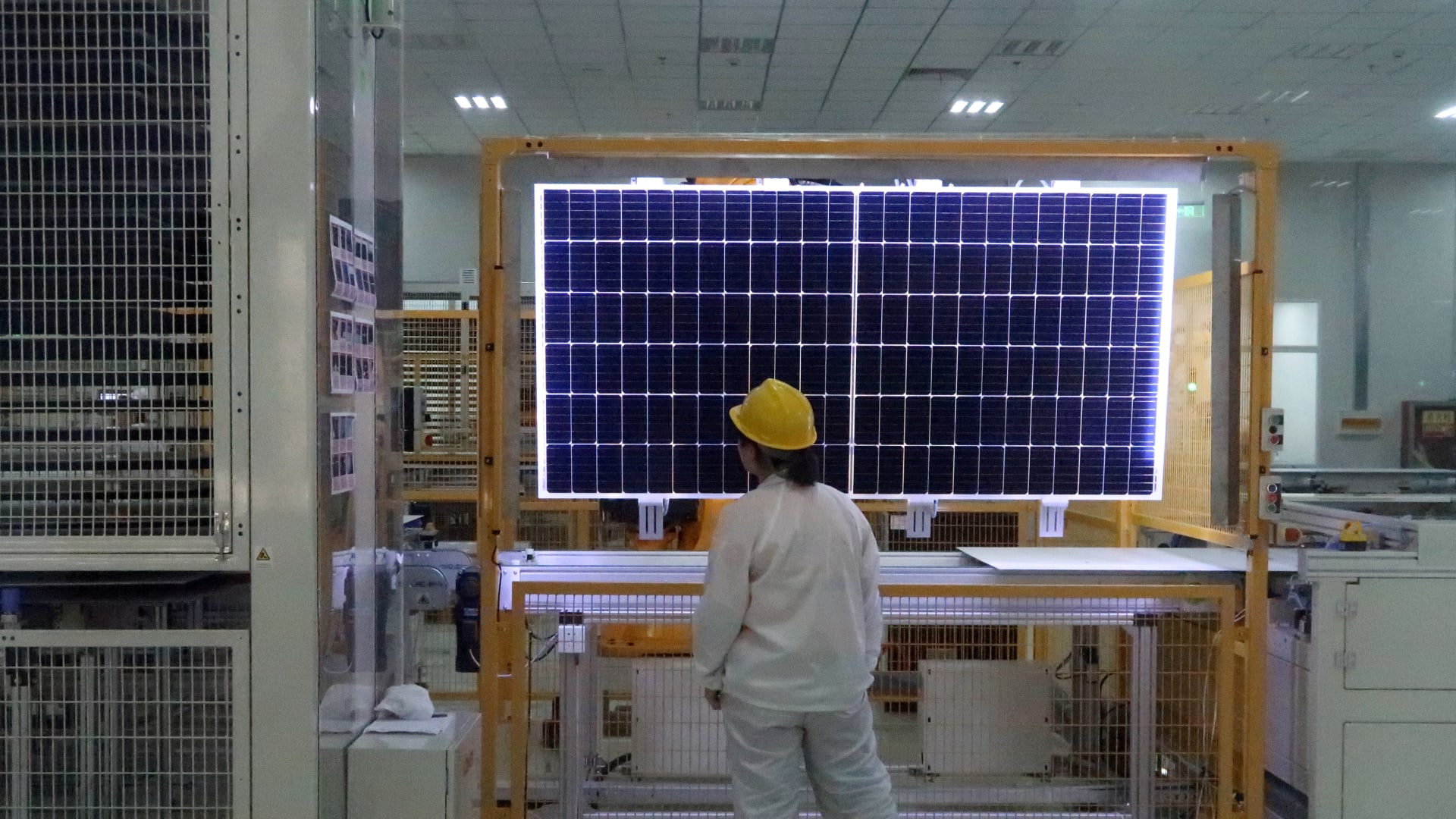 A worker conducts quality-check of a solar module product at a factory of a monocrystalline silicon solar equipment manufacturer LONGi Green Technology Co, in Xian, Shaanxi province, China December 10, 2019. Picture taken December 10, 2019. REUTERS/Muyu Xu