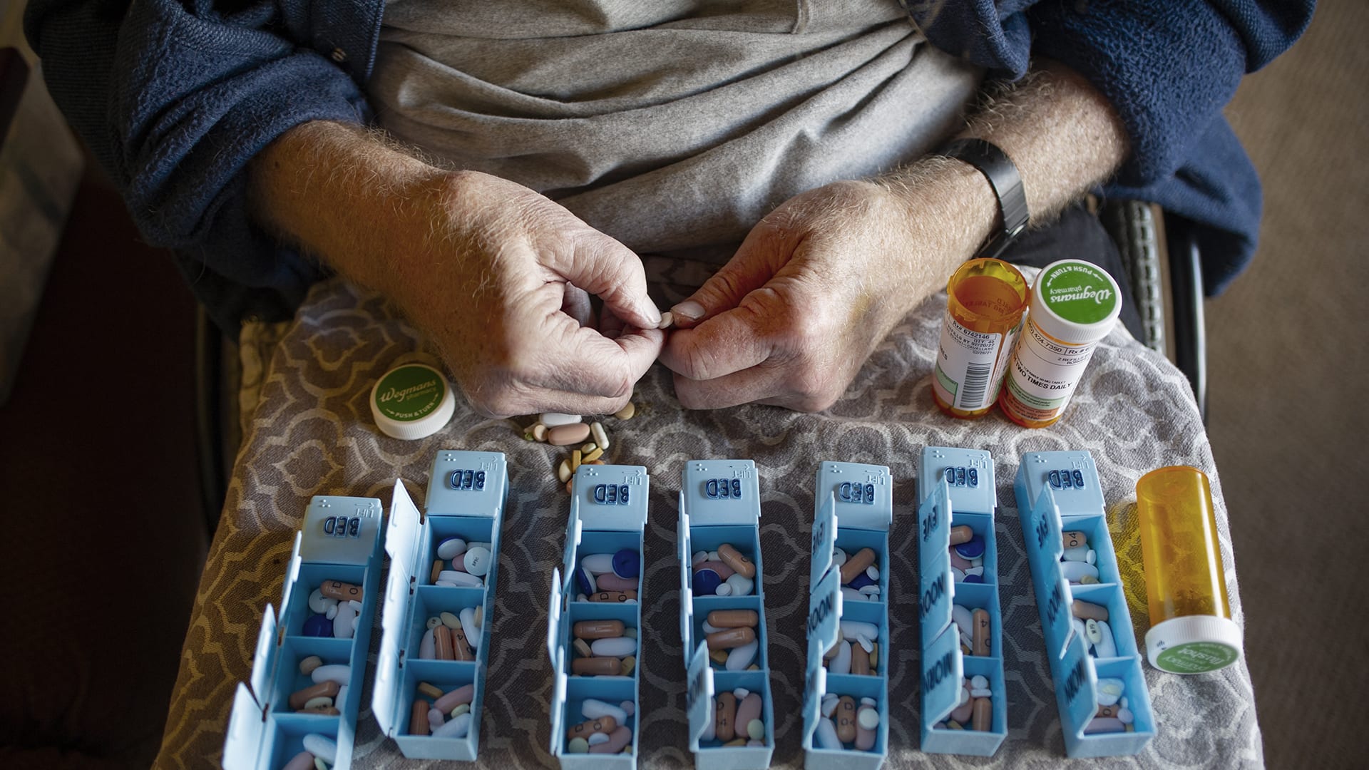 Disabled person with Multiple Sclerosis hand sorting prescription pills