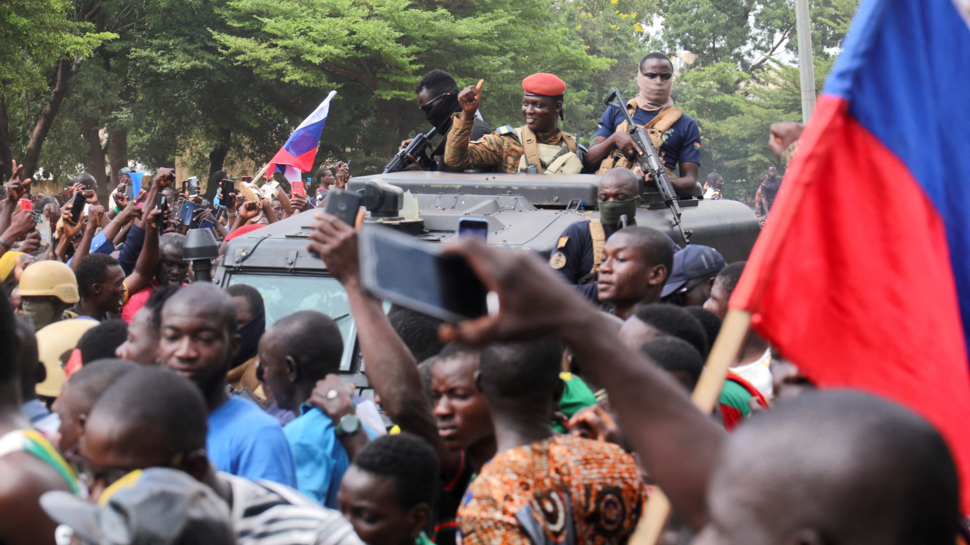 Burkina Faso’s self-declared leader Ibrahim Traore is surrounded by supporters holding Russian flags in Ouagadougou, Burkina Faso, on October 2, 2022.