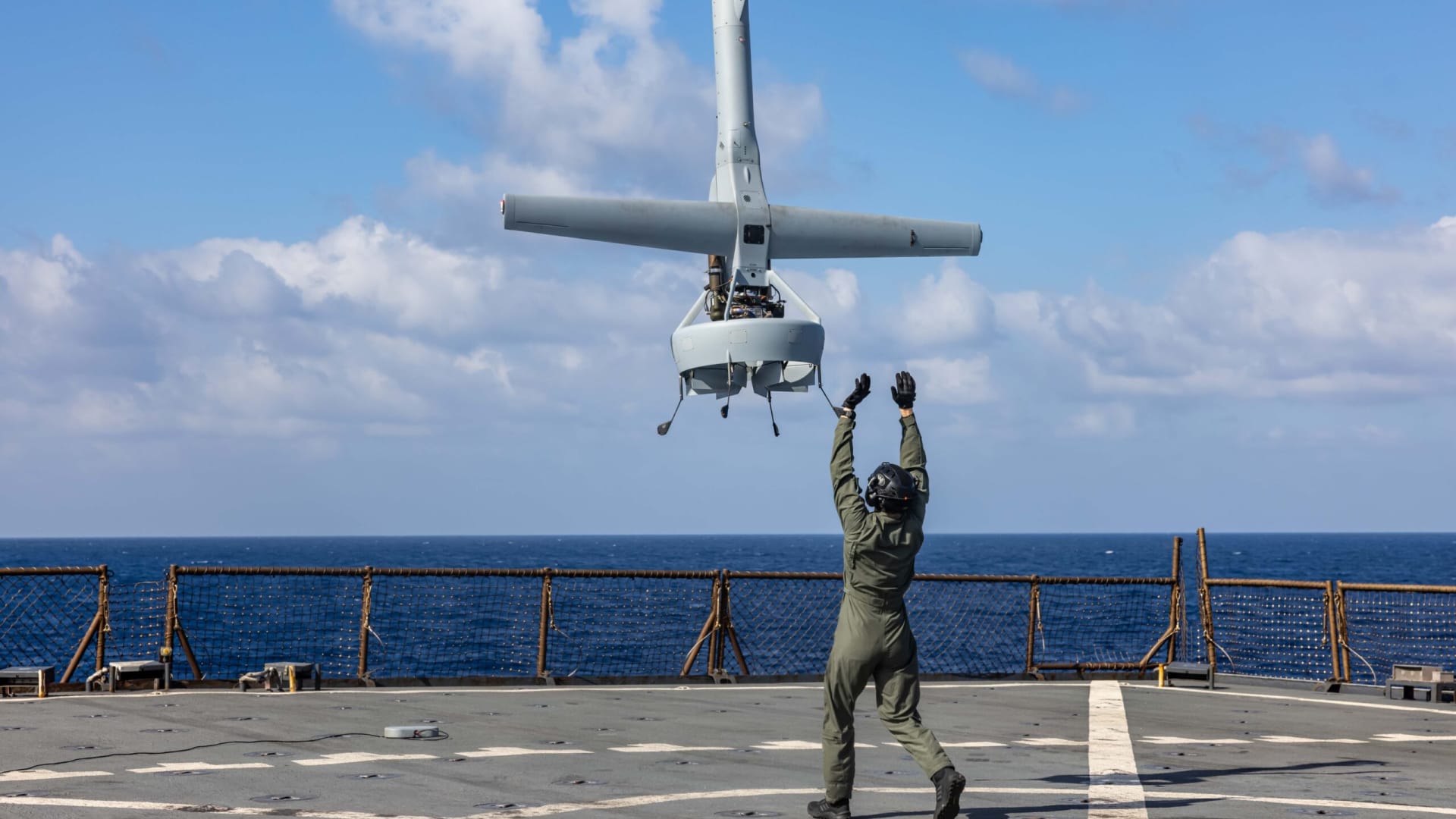 A U.S. Marine launches a VBAT on the deck of the USS Carter Hall.