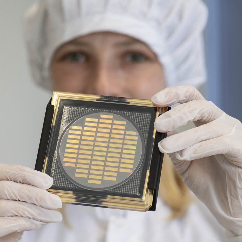 <p>An engineer shows a wafer with photonic chips for quantum computing at the company Q.ANT.</p>
