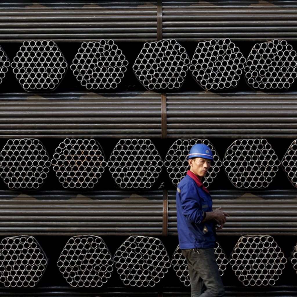 <p>A worker stands in front of steel piping at a plant in China’s Hebei Province.</p>
