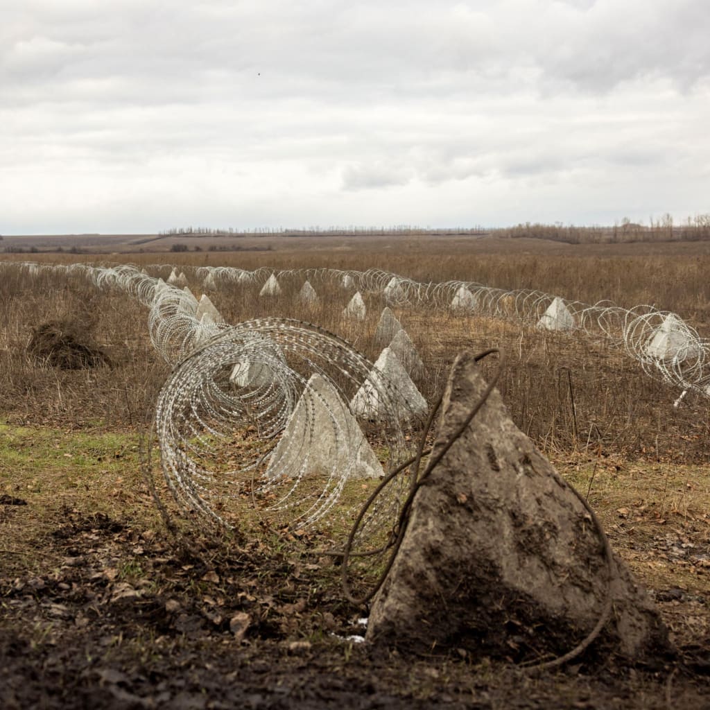 <p>Fortifications built by the Ukrainian army stretch across a field near the front line outside Kupiansk, Ukraine.</p>
