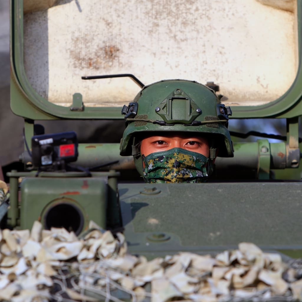 <p>A Taiwanese soldier peers out of a tank during the thirty-seventh annual Han Kuang military exercise in Tainan, Taiwan, on September 14, 2021.</p>
