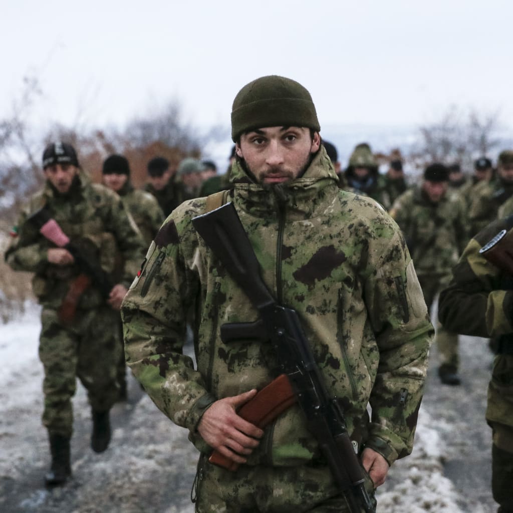 <p>Pro-Russian separatists from the Chechen “Death” battalion walk during a training exercise in the territory controlled by the self-proclaimed Donetsk People’s Republic, eastern Ukraine, on December 8, 2014.</p>

