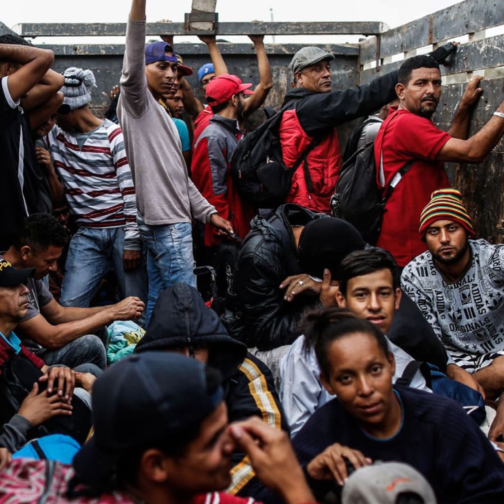 <p>Venezuelan migrants travel aboard a truck in Tumbes, Peru, on November 1, 2018.</p>
