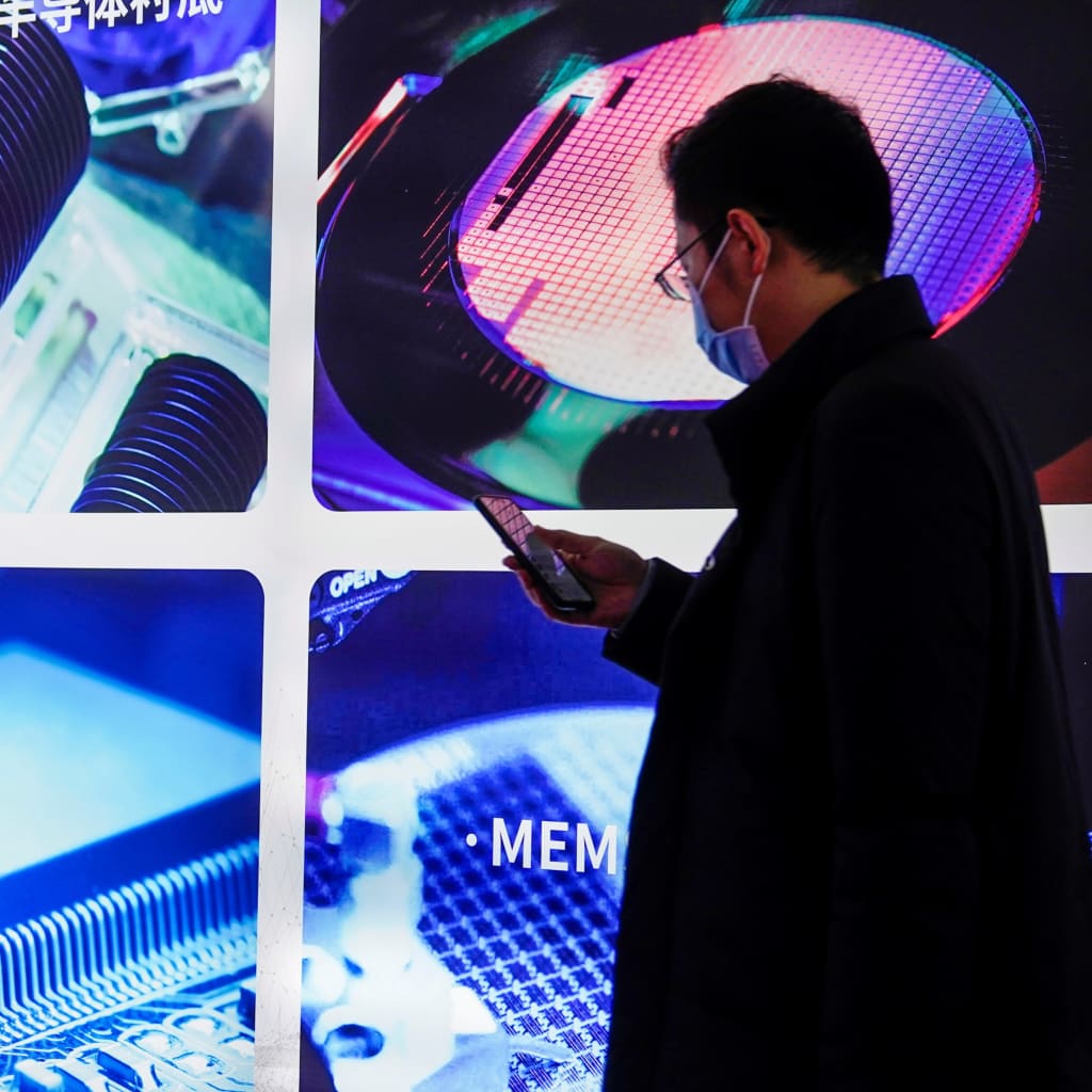 <p>A man visits a display of semiconductor devices at Semicon China, a trade fair for semiconductor technology, in Shanghai, March 17, 2021.</p>
