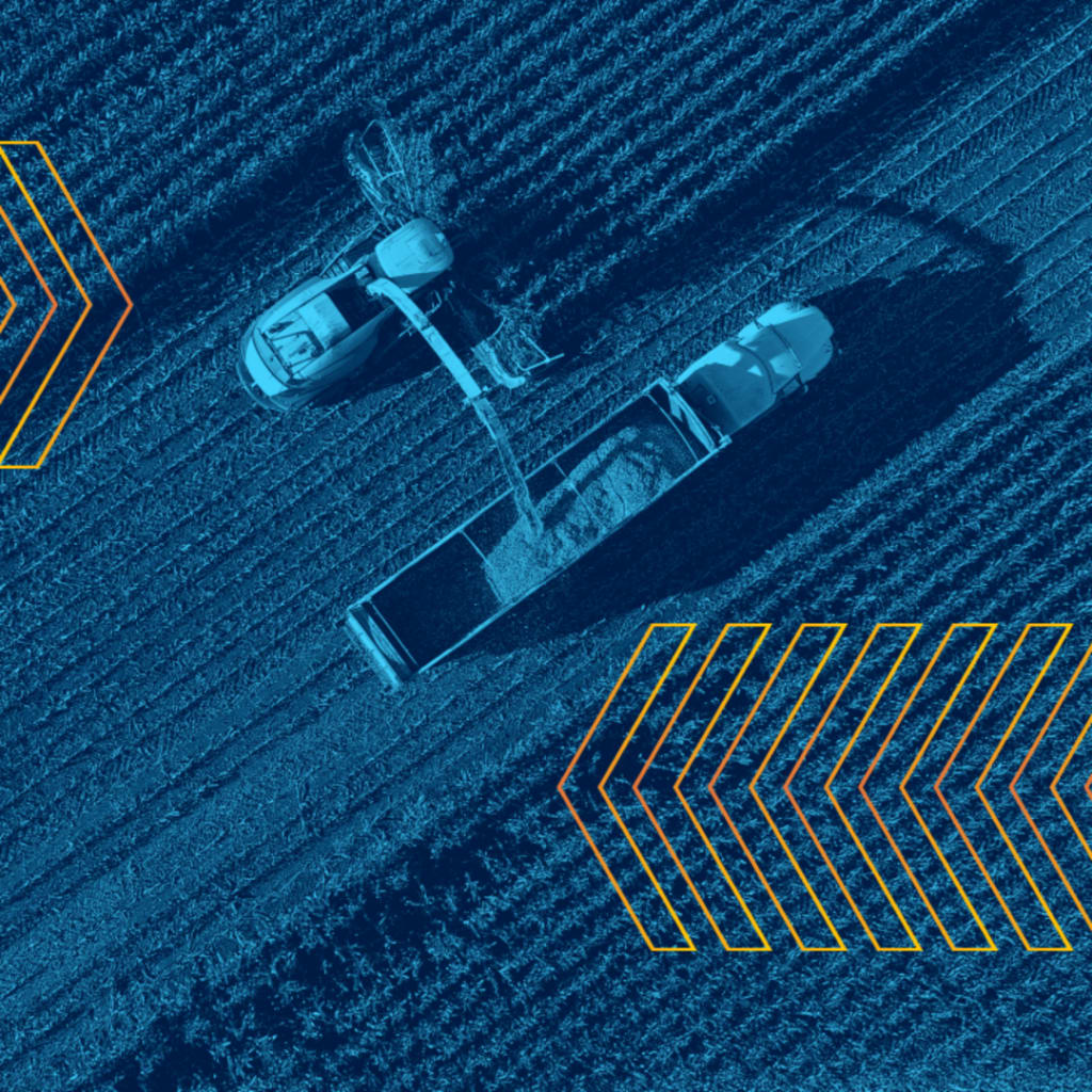 <p>Aerial view of tractors harvesting crop.</p>