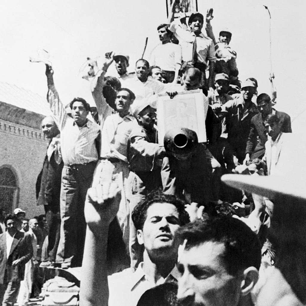 Iranians carry a portrait of the shah through the streets of Tehran after the overthrow of Prime Minister Mohammed Mossadeq. 
