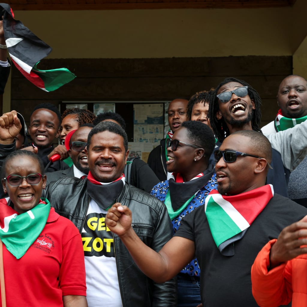 <p>Kenyan activists protest after human rights activist Boniface Mwangi was charged with unlawful possession of ammunition over his alleged role in deadly anti-government protests in June, at the Kahawa Law Courts in Kiambu County, Kenya July 21, 2025. </p>
