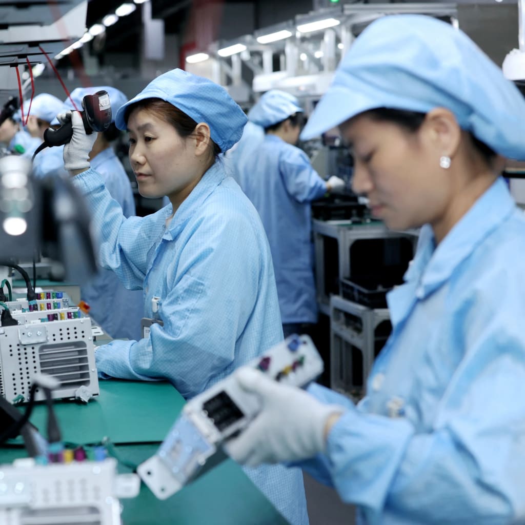 <p>Workers assembling automotive navigation products at a factory in Suqian, Jiangsu Province, China on April 9, 2025.</p>
