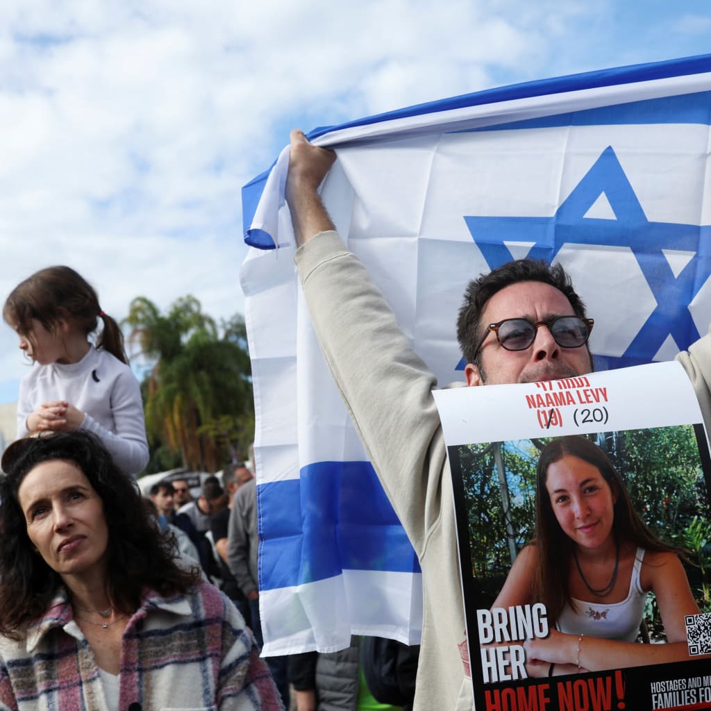 <p>A crowd in Tel Aviv watches a broadcast of the release of Israelis held hostage by Hamas on January 25, 2025.</p>
