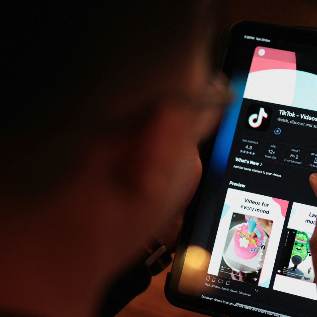 <p>A man poses for a photo while downloading TikTok on his device after Albanian Prime Minister Edi Rama announced plans to ban TikTok in January, in Tirana, Albania December 29, 2024.</p>
