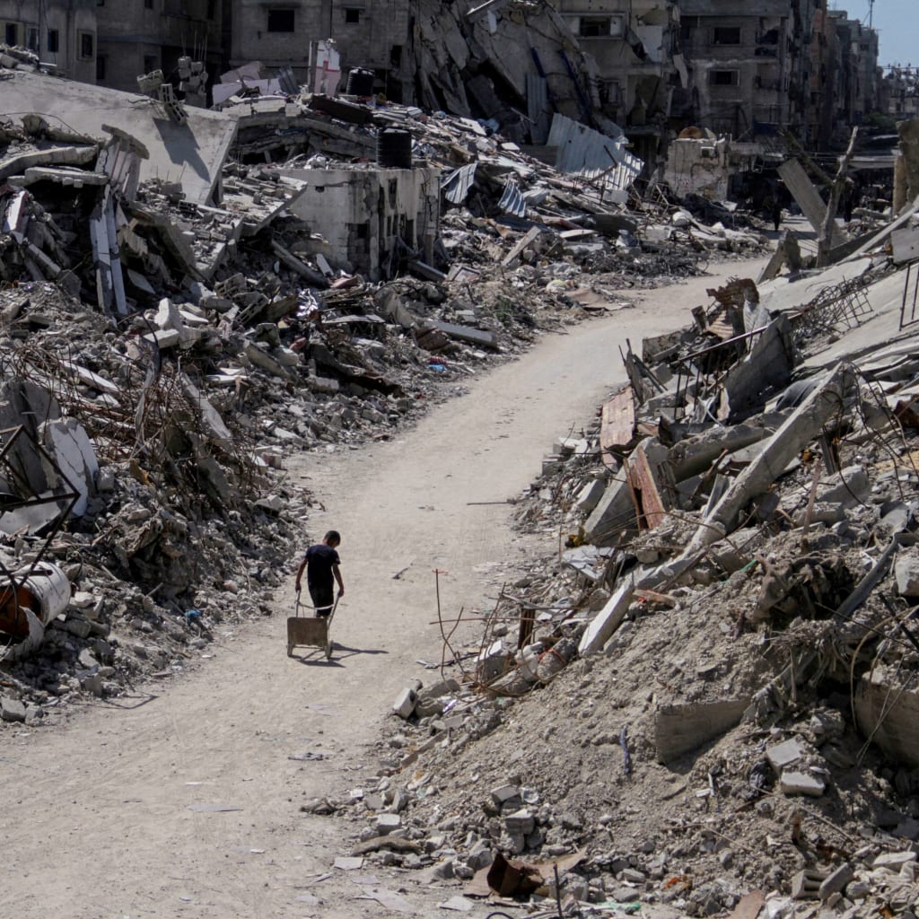 <p>A Palestinian walks among the rubble of damaged buildings, which were destroyed during Israel’s military offensive, amid the ongoing conflict between Israel and Hamas, in Beit Lahia in the northern Gaza Strip, June 12, 2024.</p>
