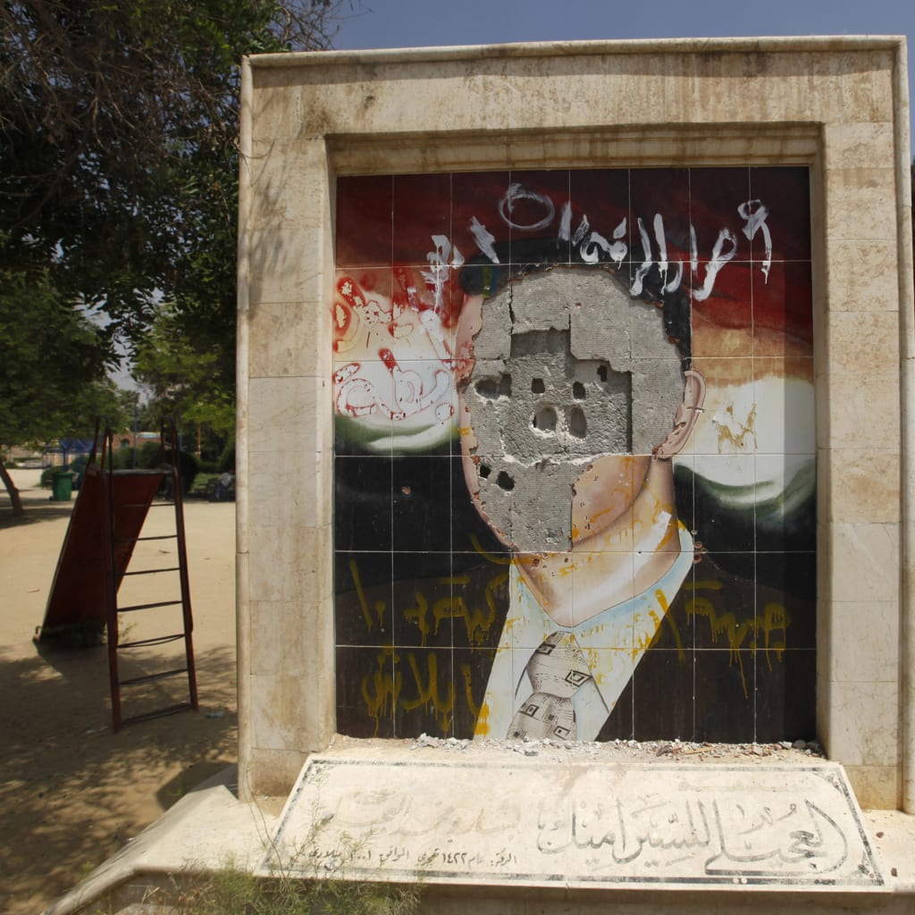 <p>A vandalised mosaic picture of Syria’s President Bashar al-Assad is pictured in Raqqa province, east Syria May 1, 2013. </p>
