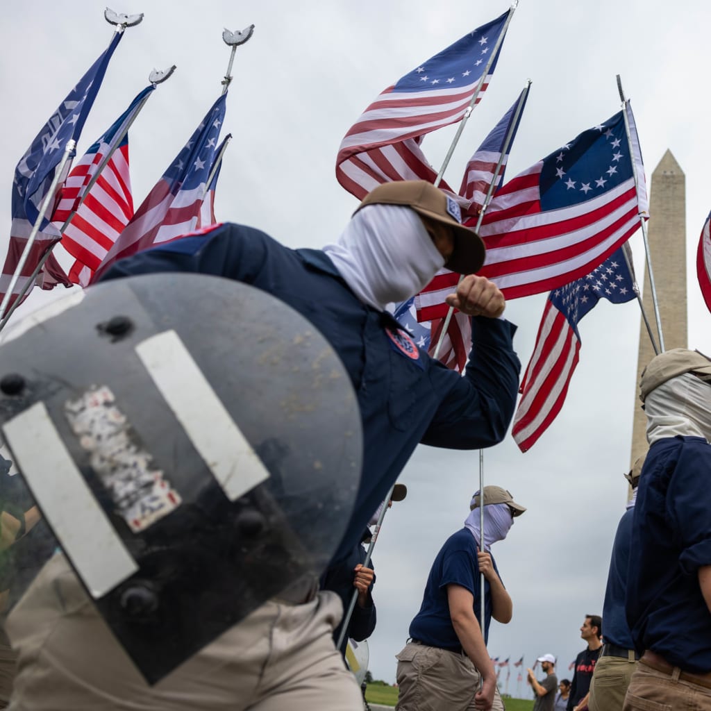 <p>January 6th protesters clad with shields and American flags march on Washington.</p>
