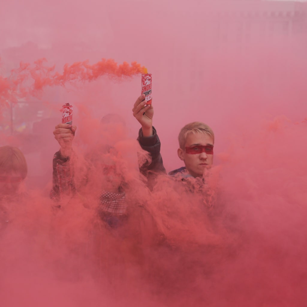 <p>People hold flares during a protest at Independence Square in Kyiv.</p>
