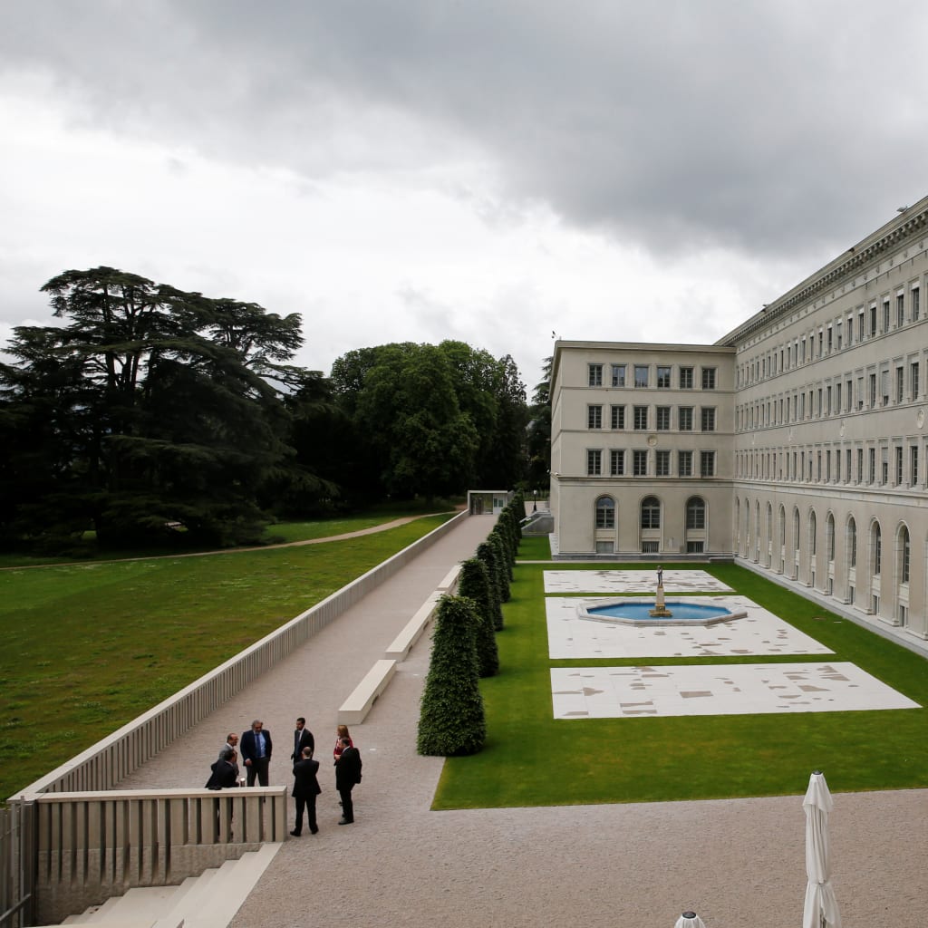 <p>People gather outside the World Trade Organization in Geneva.</p>
