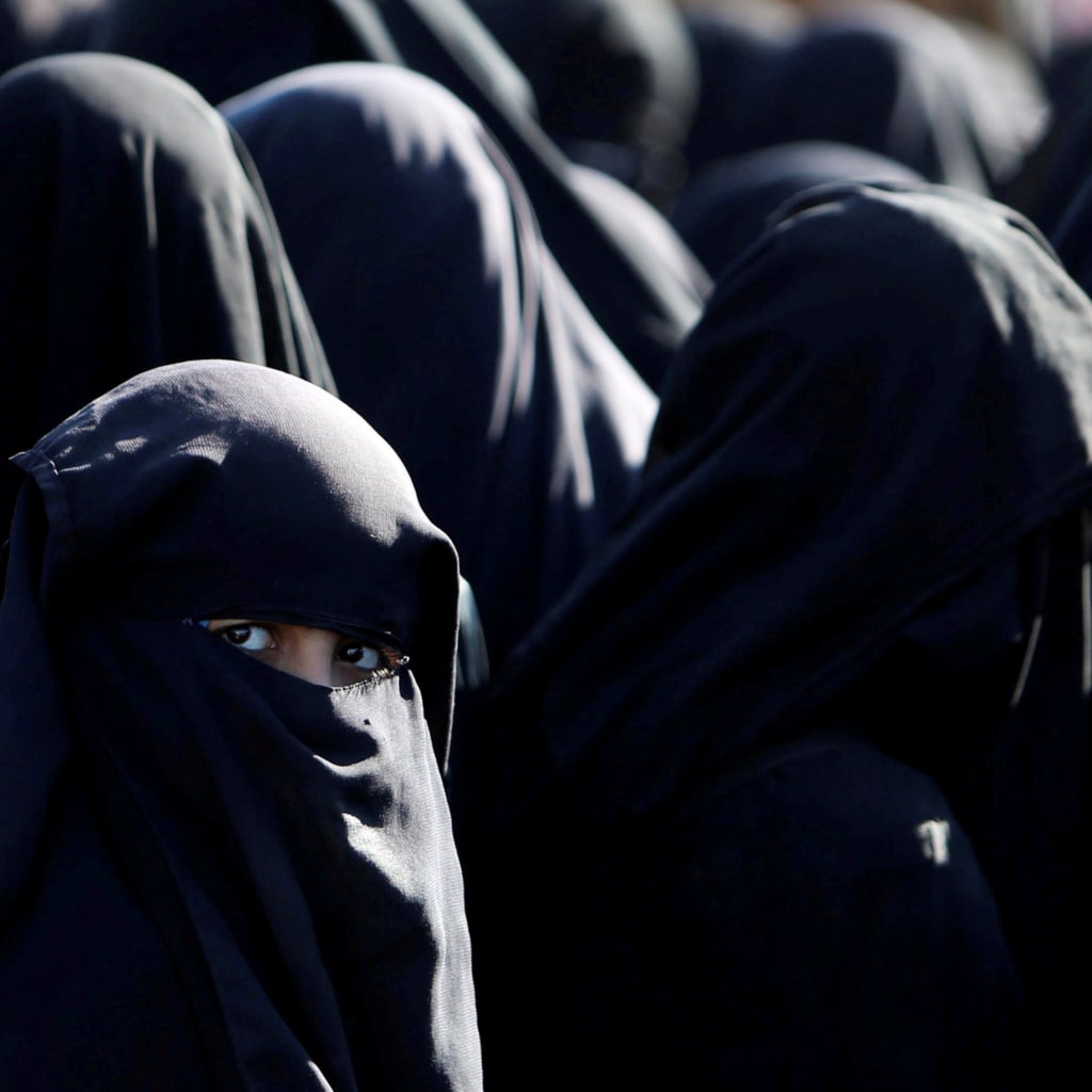 <p>Women stand together at al-Hol camp in Syria.</p>
