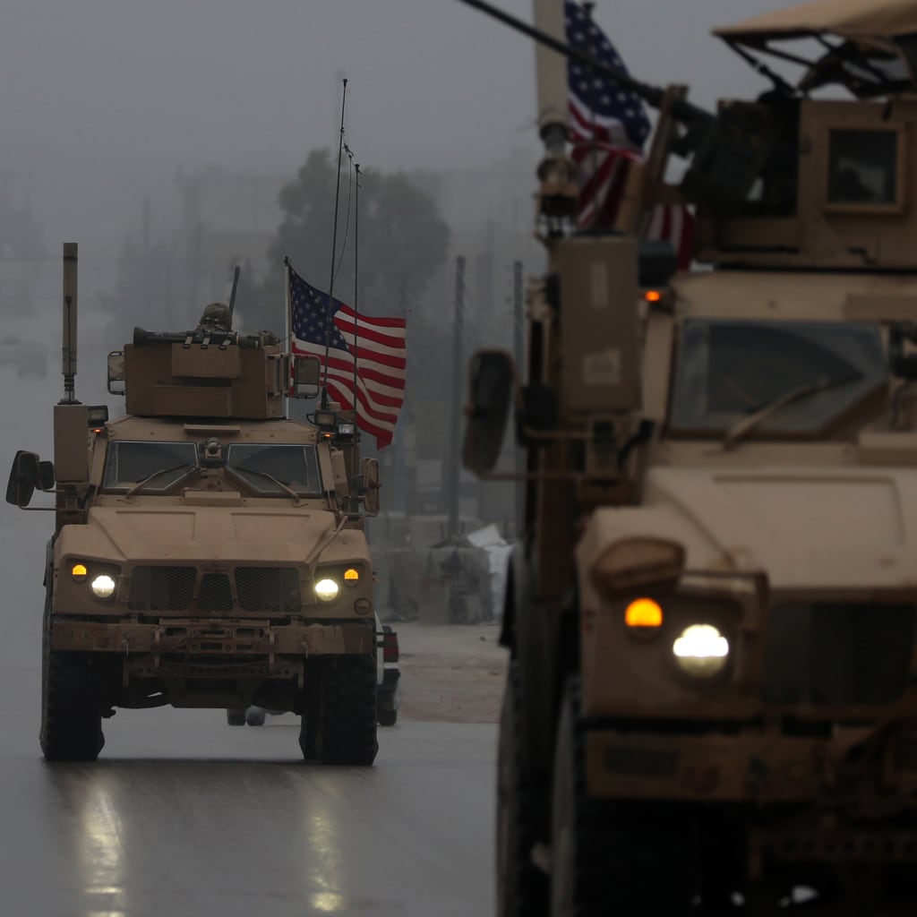 <p>U.S. military vehicles drive through northern Syrian city of Manbij, December 30, 2018.</p>
