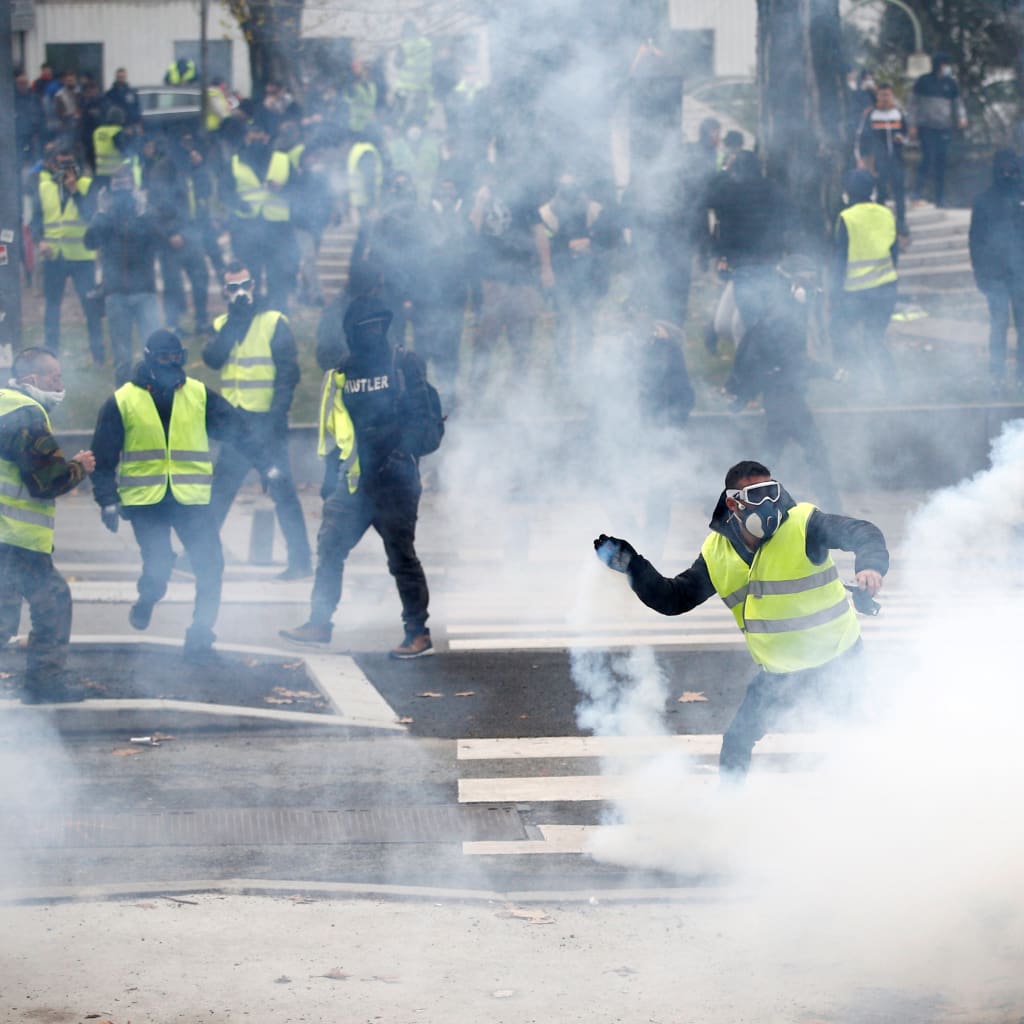 <p>Protesters wearing yellow vests clash with police during a demonstration of the “yellow vests” movement in Nantes, France, December 22, 2018.</p>
