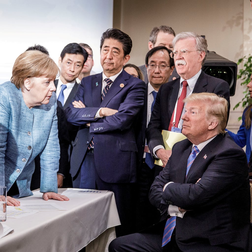 <p>German Chancellor Angela Merkel speaks to U.S. President Donald Trump during the second day of the G7 meeting in Quebec, Canada.</p>