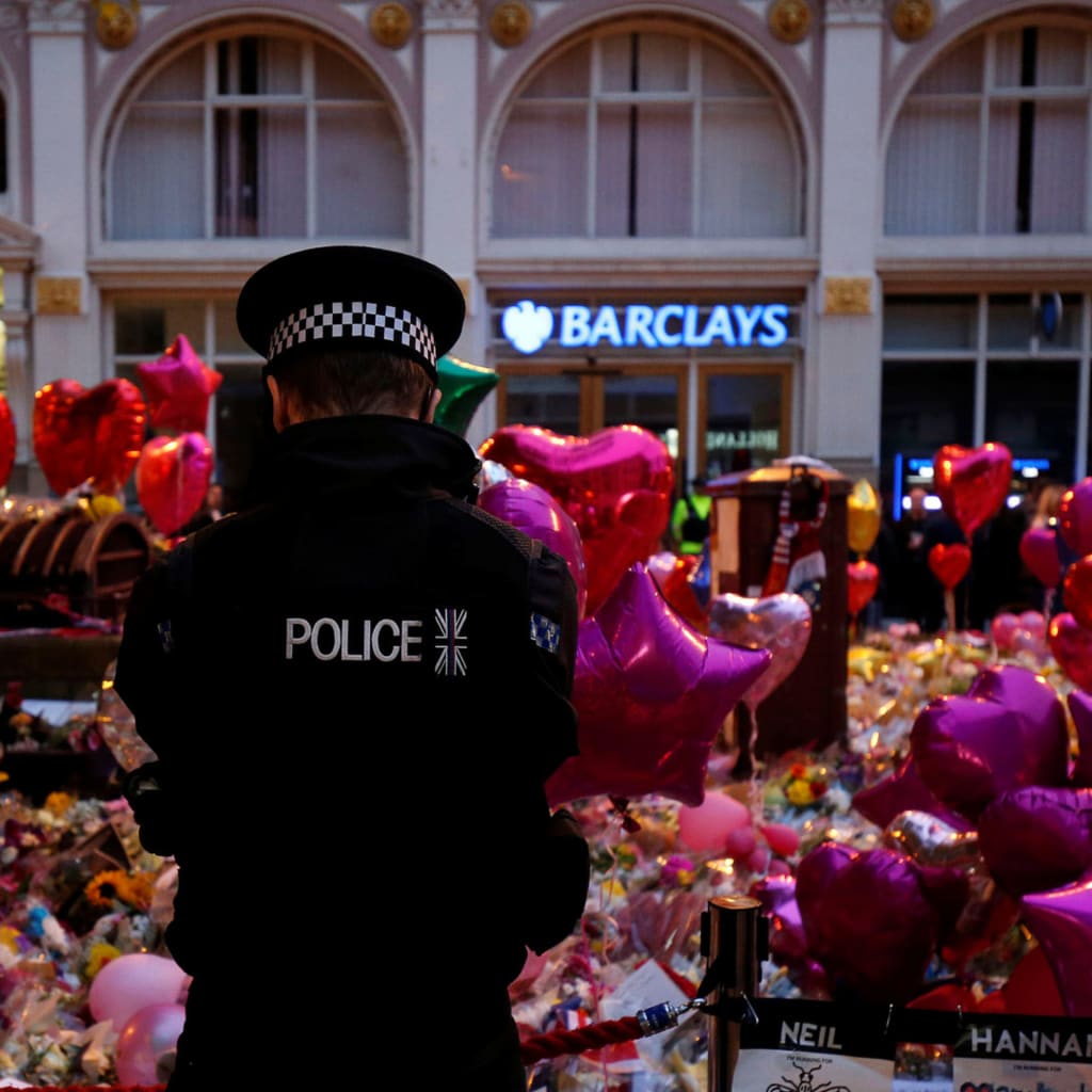 <p>A police officer stands at a vigil for the victims of the attack at a concert in Manchester.</p>
