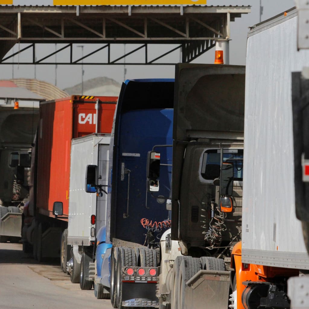 <p>Trucks wait to cross border customs control at the Otay border crossing in Tijuana, Mexico, February 2, 2017</p>
