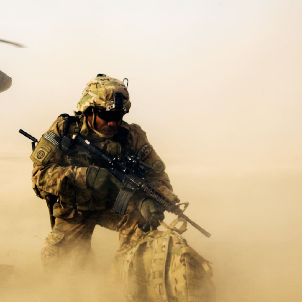 <p>A U.S. soldier  shields himself from the rotor wash of a Blackhawk helicopter after being dropped off for a mission with the Afghan police in the Nangarhar province of Afghanistan.</p>
