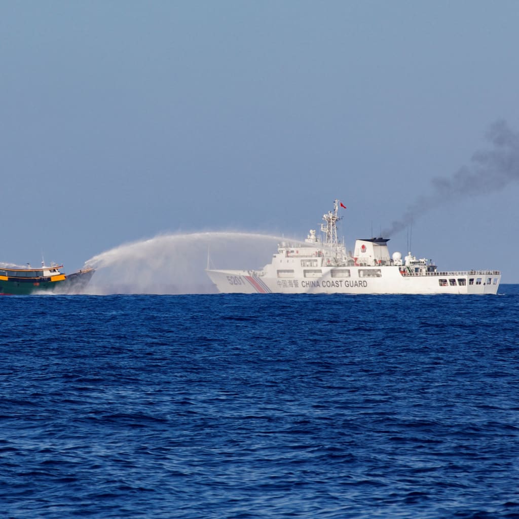 <p>Chinese Coast Guard vessels fire water cannons toward a Philippine resupply vessel en route to the Second Thomas Shoal on March 5, 2024. </p>
