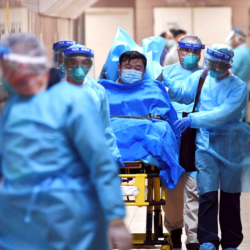 <p>Medical staff transfer a patient of a highly suspected case of a new coronavirus at the Queen Elizabeth Hospital in Hong Kong, January 22, 2020.</p>
