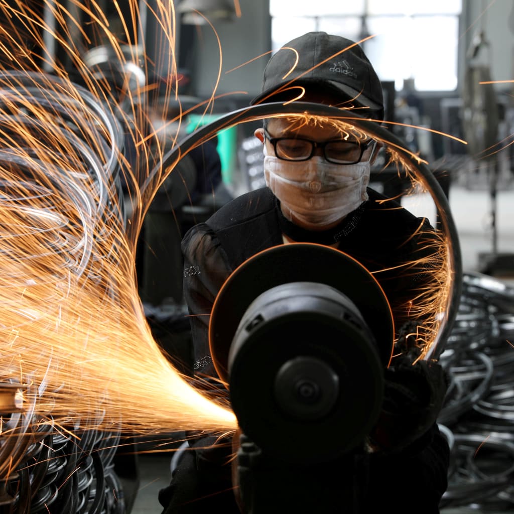 <p>A worker polishes a bicycle steel rim at a factory manufacturing sports equipment in Hangzhou, China on September 2, 2019.</p>