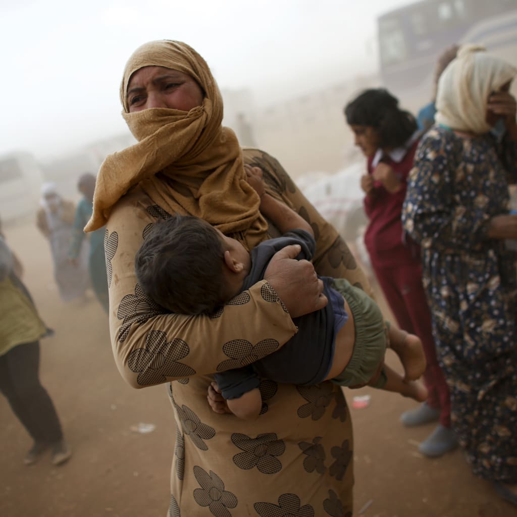 <p>A Kurdish Syrian refugee on the Turkey-Syria border.</p>
